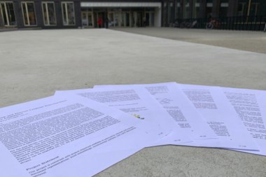 The printed GAČR project proposal laying on the concrete (pun intended) in front of the Faculty of Informatics at the Masaryk University in Brno, Czech Republic