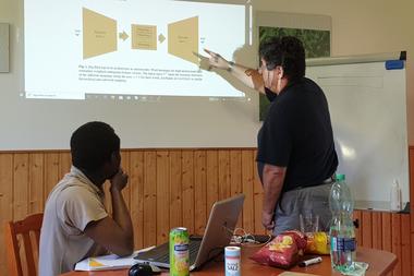 Petr Sojka (right) explaining the Big Bird language model architecture to Eniafe Festus Ayetiran at RAMIRA 2020